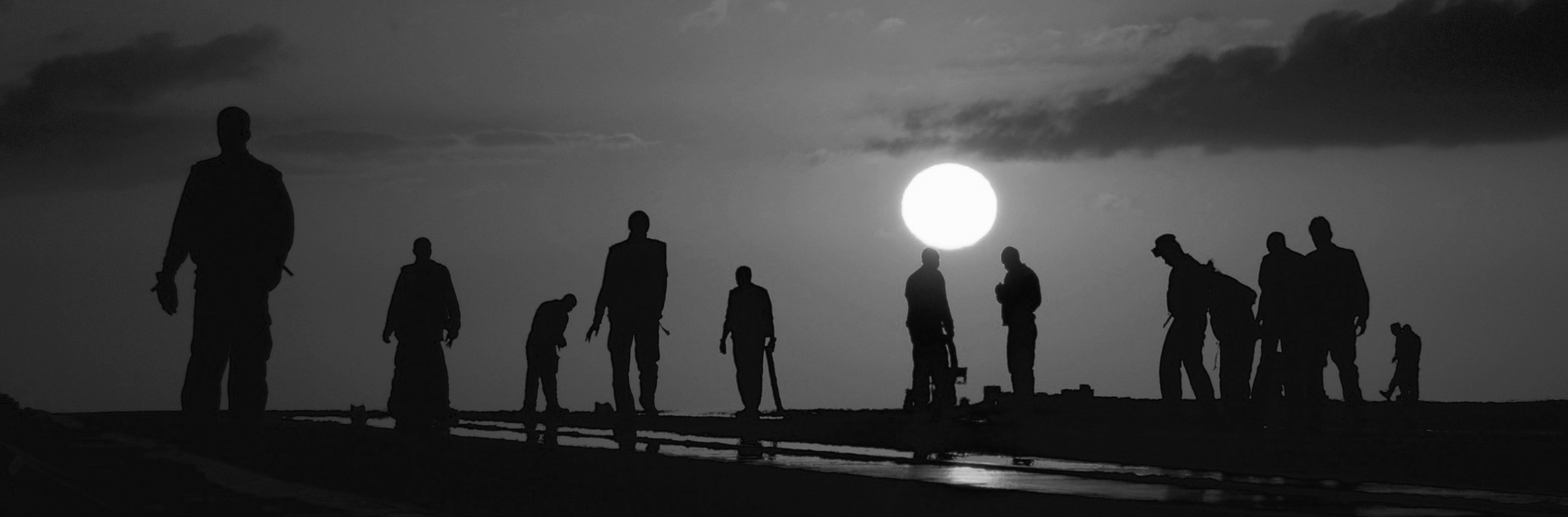 14 Orange Greyscale Image people on a beach in moonlight