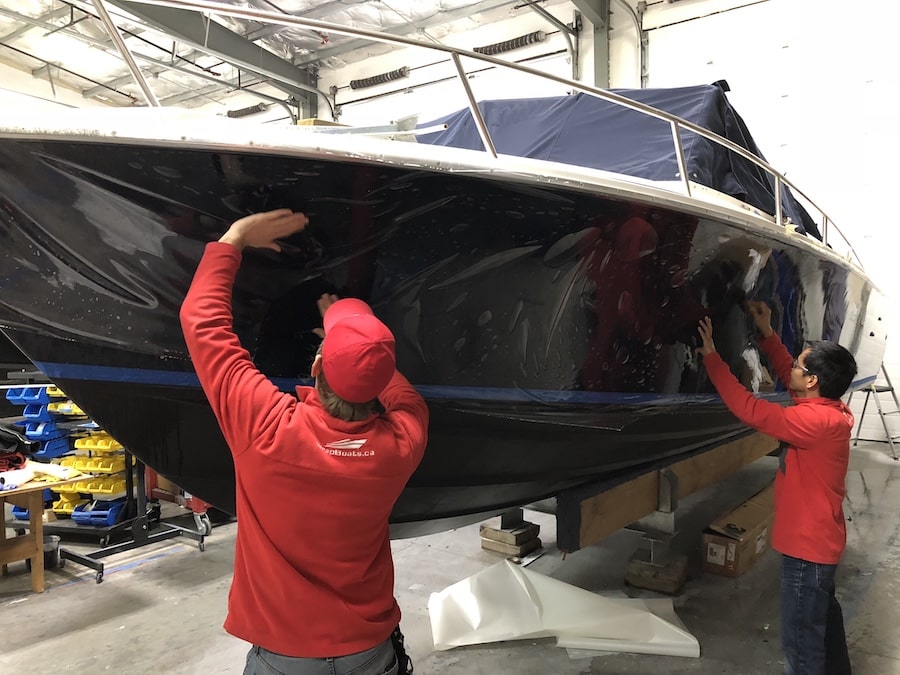 14 Oranges WrapBoats.ca Workers wrapping boat for winter