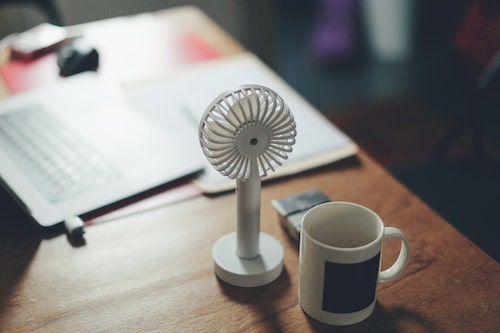 14 Oranges Desk with Hand Oscellating Fan and mug